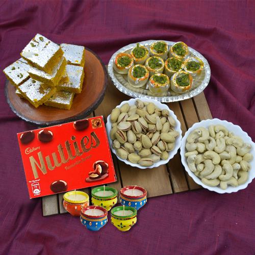 Alluring Gift of Haldiram Sweets, Dry Fruits, Chocolates n Wax Diya